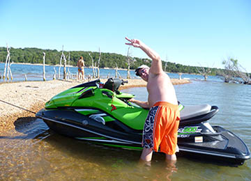 man with jetski waving