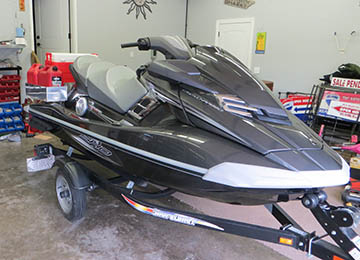 front quarter view of jetski loaded with extra gas cans and coolers