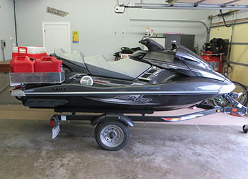 side view of jetski loaded with extra gas cans and coolers